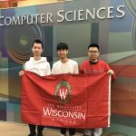 Three team members in front of the Computer Sciences sign.