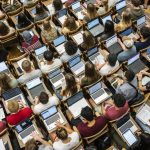 Aerial shot of students in class on laptops